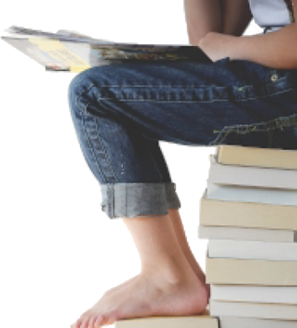 Youth with bare feet, sitting on a pile of books and studying.